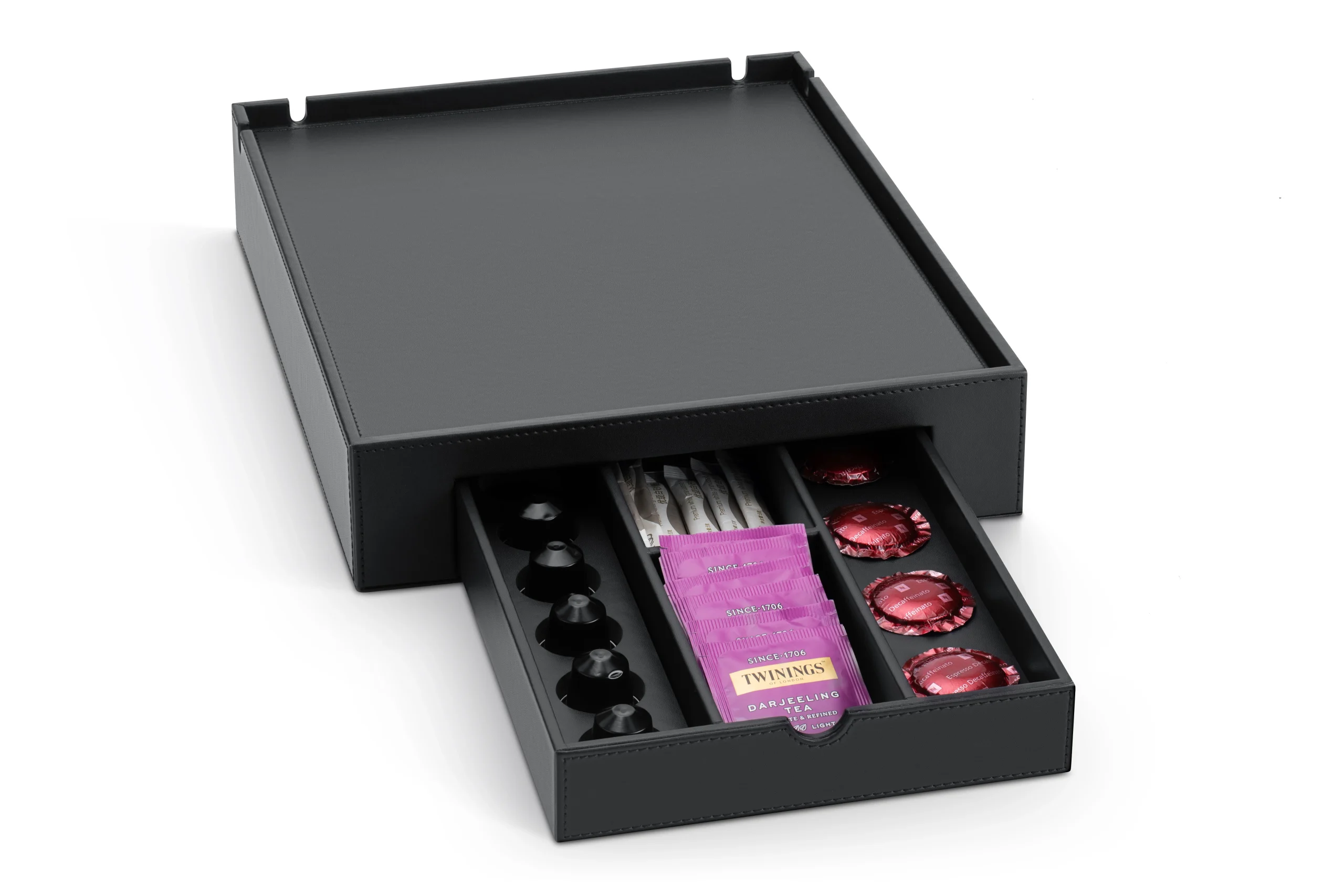 Black faux leather hospitality tray with drawer open showing assorted coffee pods