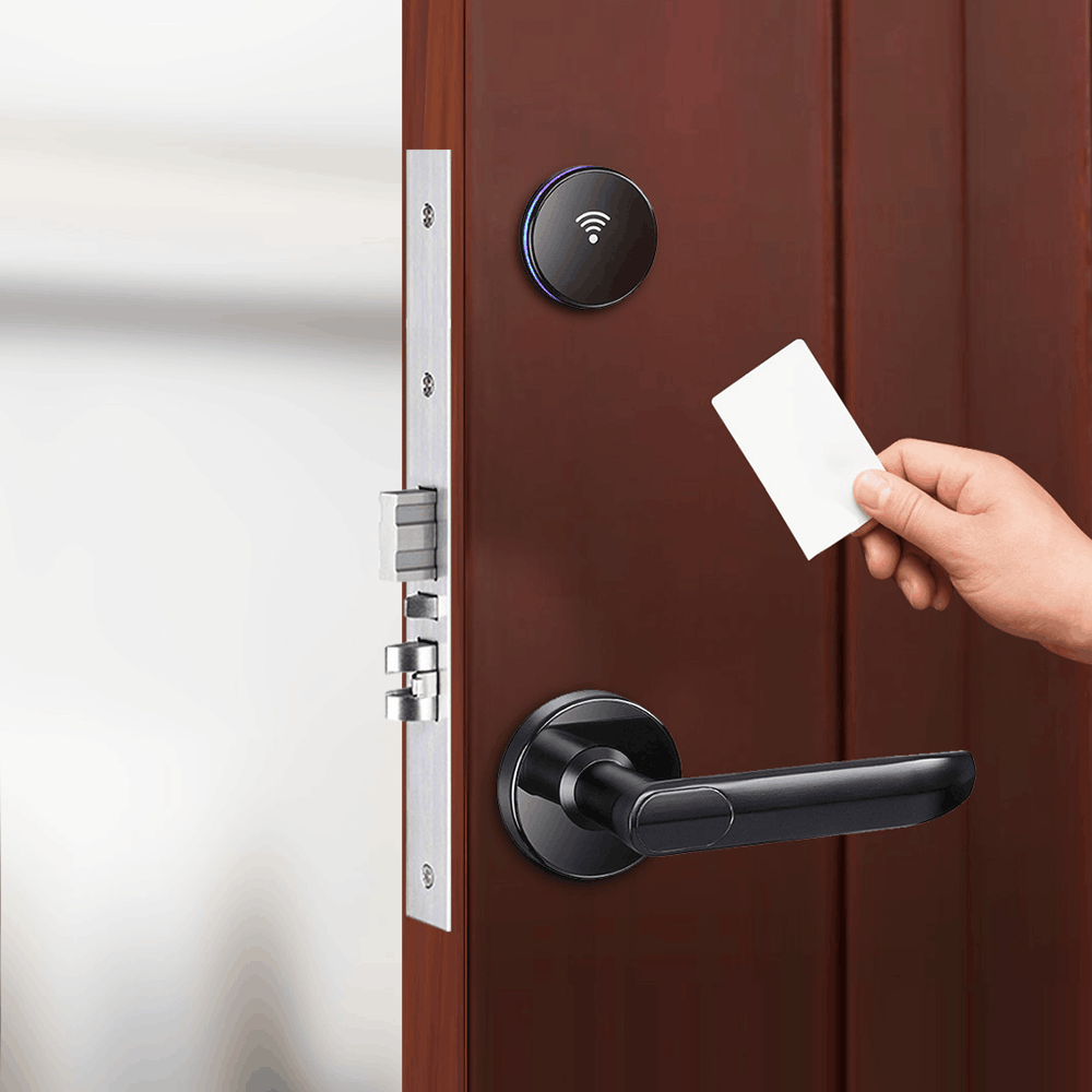 Guest holding a key card beside the HLS190 hotel lock with black handle