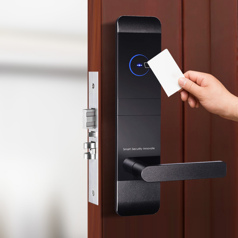 HLS900 smart hotel lock on a hotel door with a hand holding a keycard to activate the lock by hotel lock and safe