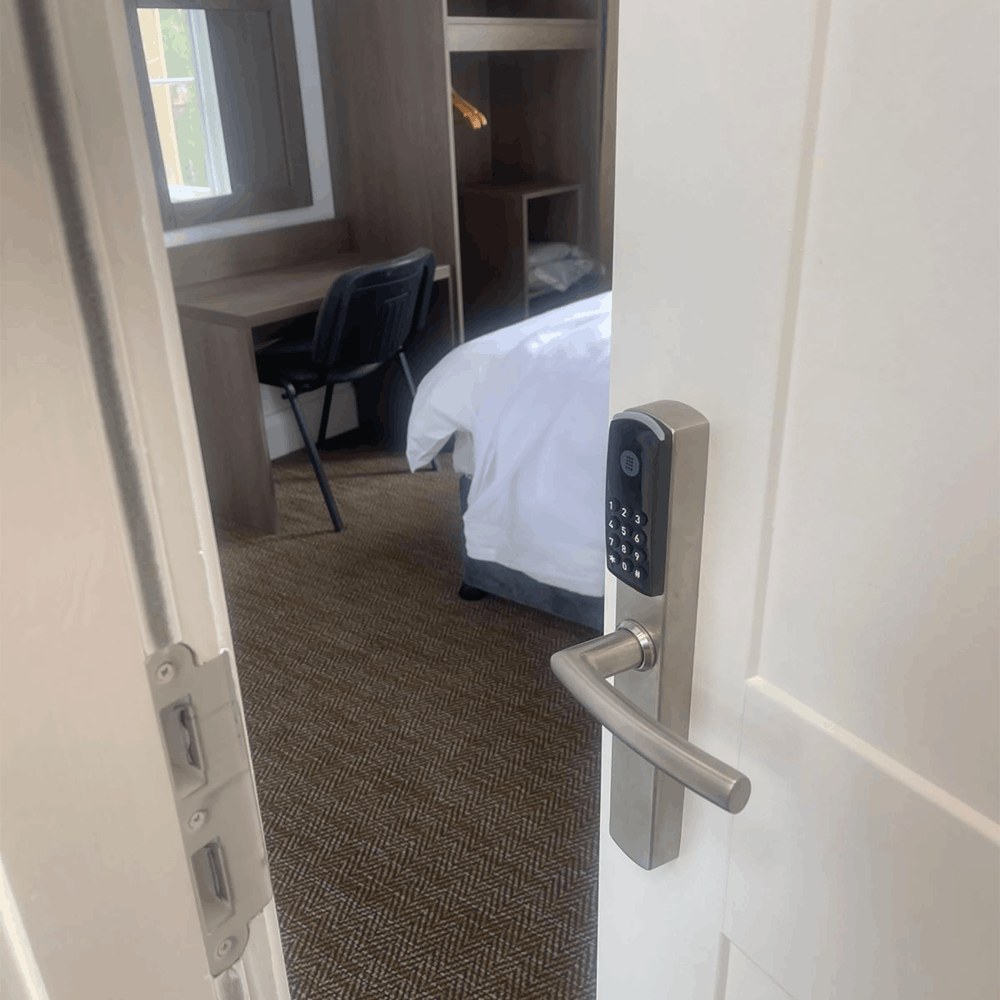 Omnitec os slim code hotel door lock on a white hotel door to a guest room by hotel lock and safe