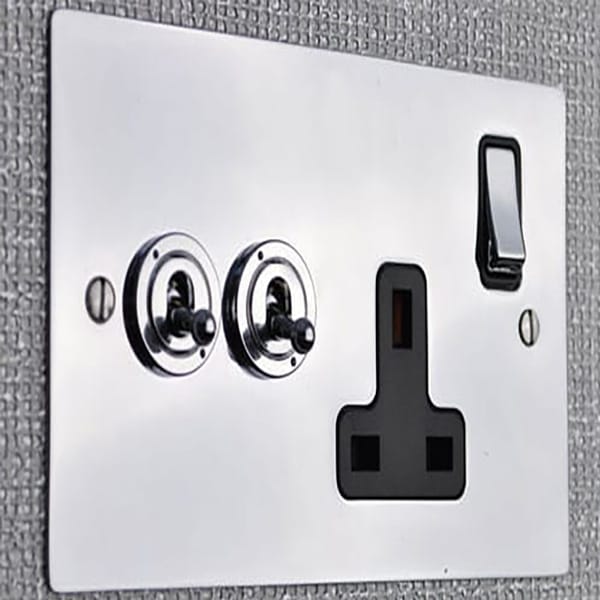Bespoke plates in silver and black, switch and plug socket fixed to a wall in a hotel guest room by Hotel lock and Safe