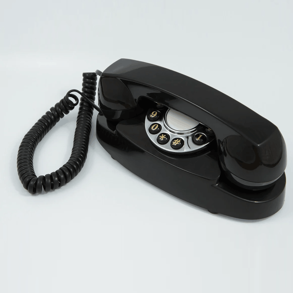 GPO Audrey Black hotel guest room accessory phone with push button dial and cloth curly cord by hotel lock and safe