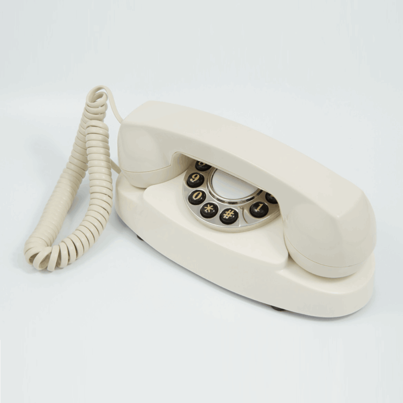 GPO Audrey Hotel guest room push button dialling phone in cream / ivory with curly cloth cord by hotel lock and safe