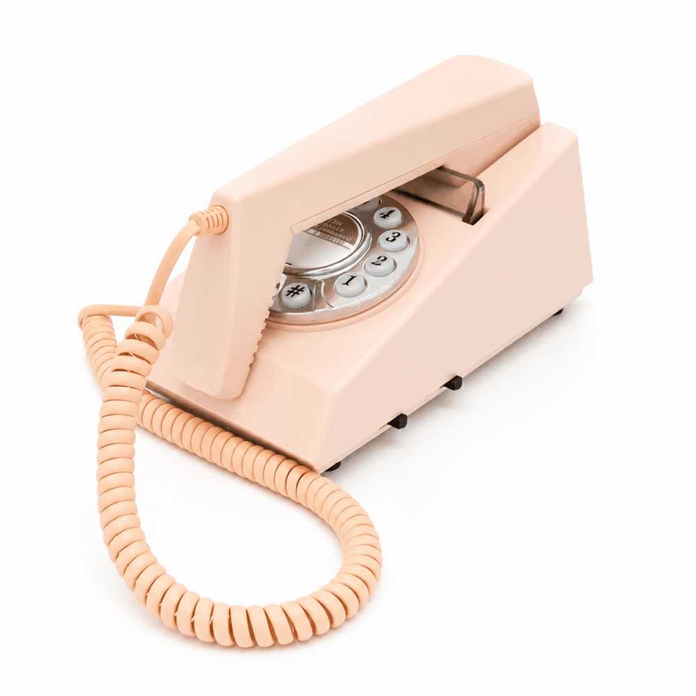 PINK coloured GPO Trim hotel guest room push button phone on a white background showing the side view by hotel lock and safe