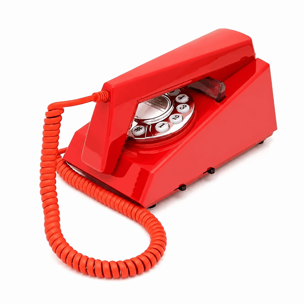 GPO Trim hotel guest room phone in red with push button dial on a white background showing the side view by hotel lock and safe